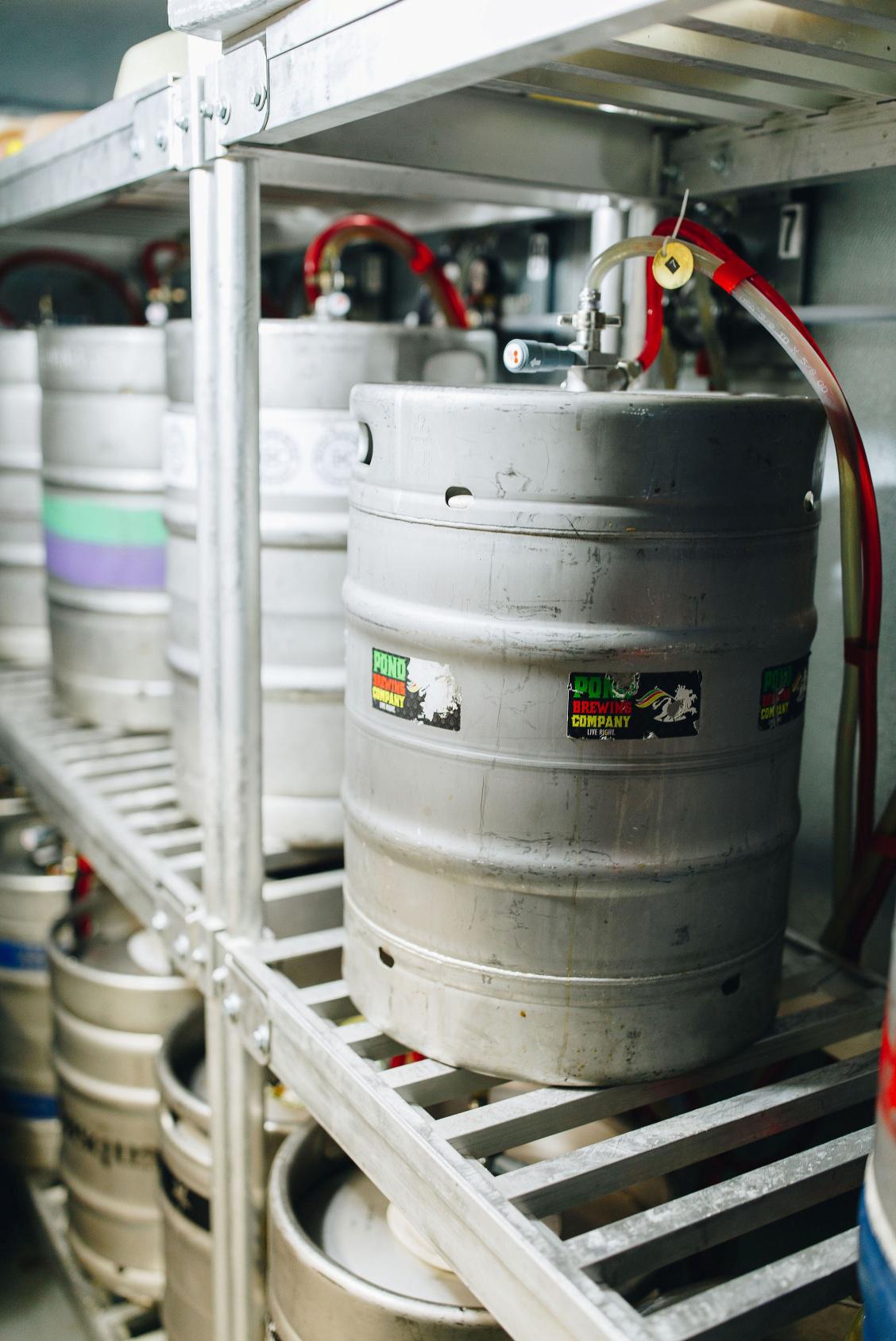 Kegs on shelves connected to draft lines
